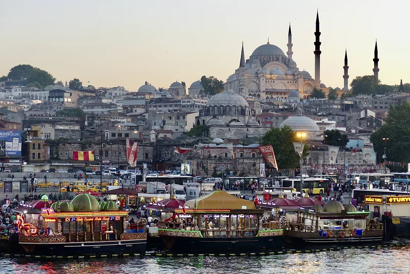 Harbour city with a mosque and minarets at dusk