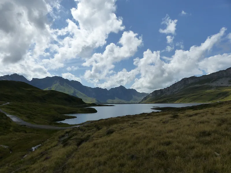 Mountain lake under a tall cloudy sky