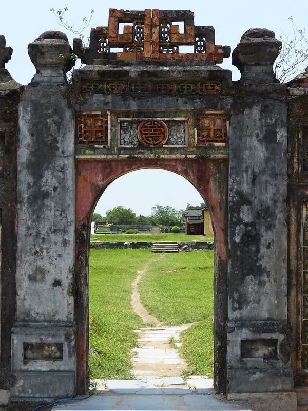 Old stone gate with a path into a garden
