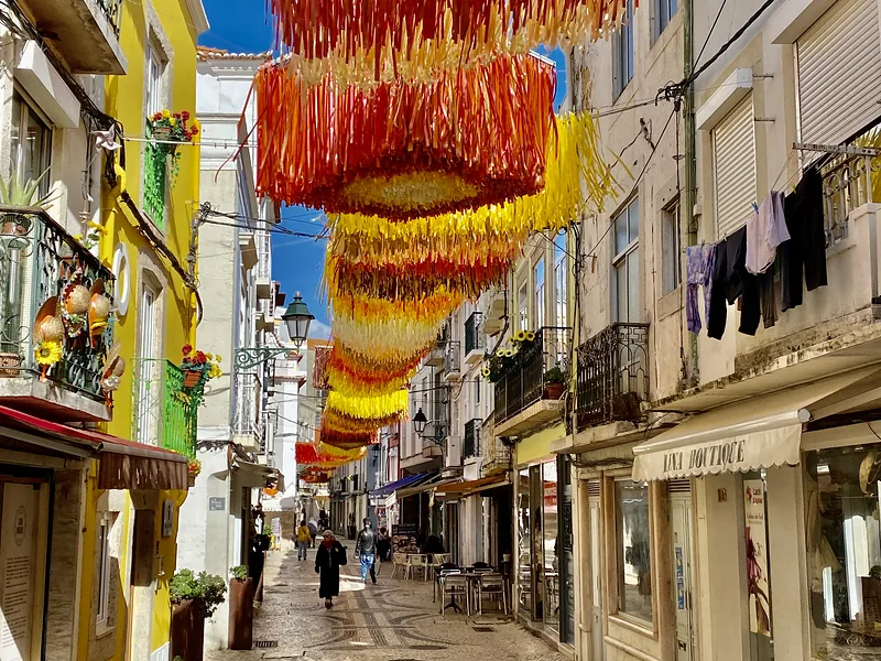 Narrow lane with colourful garlands and balconies