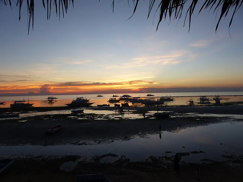 Sunset over a bay with fishing boats